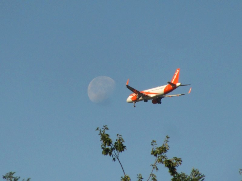 Der Mond und ein Flugzeug